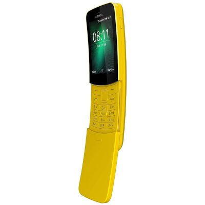 A person using the Nokia 8110 4G phone to browse the internet on a park bench.